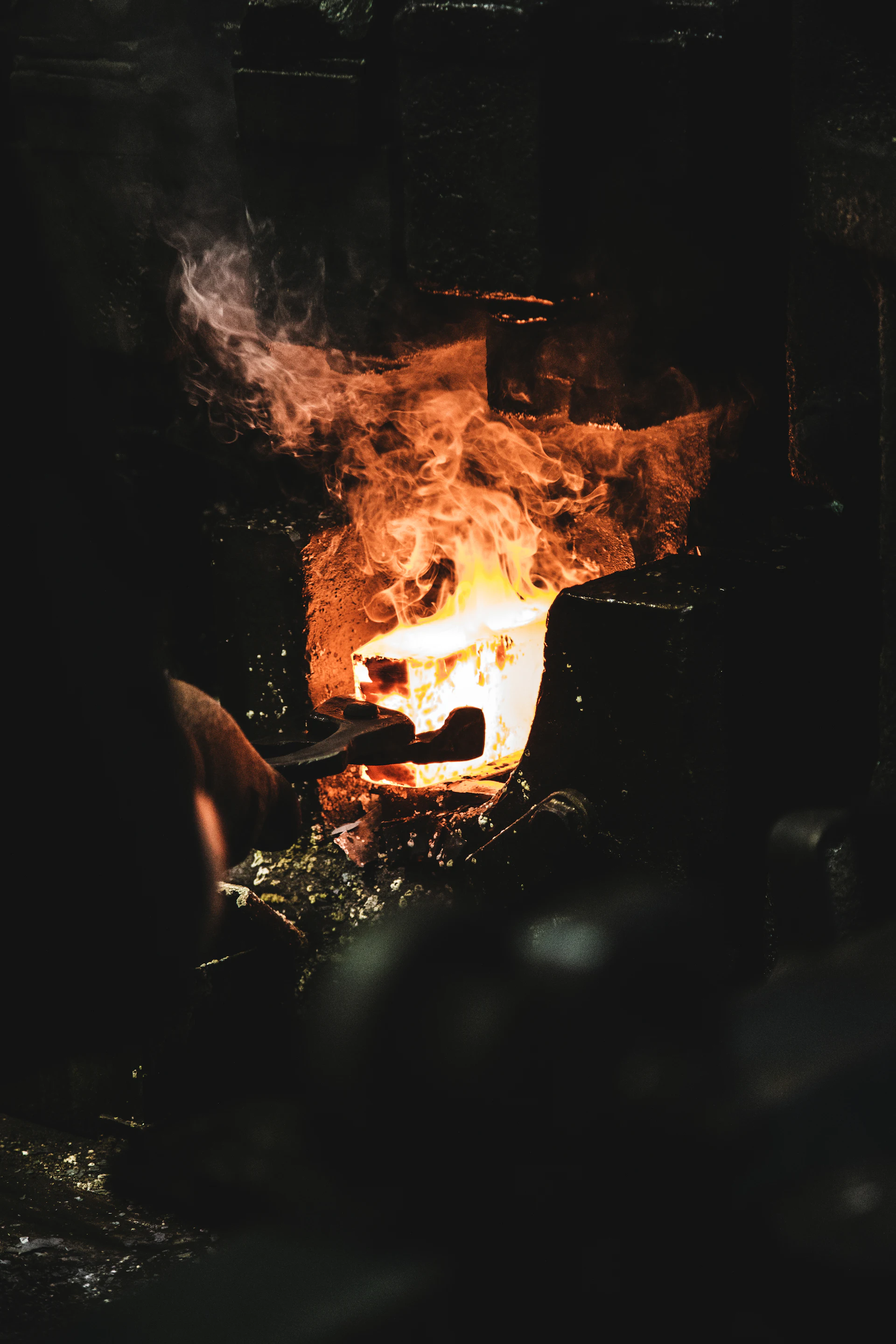 Molten metal glowing in a dark forge