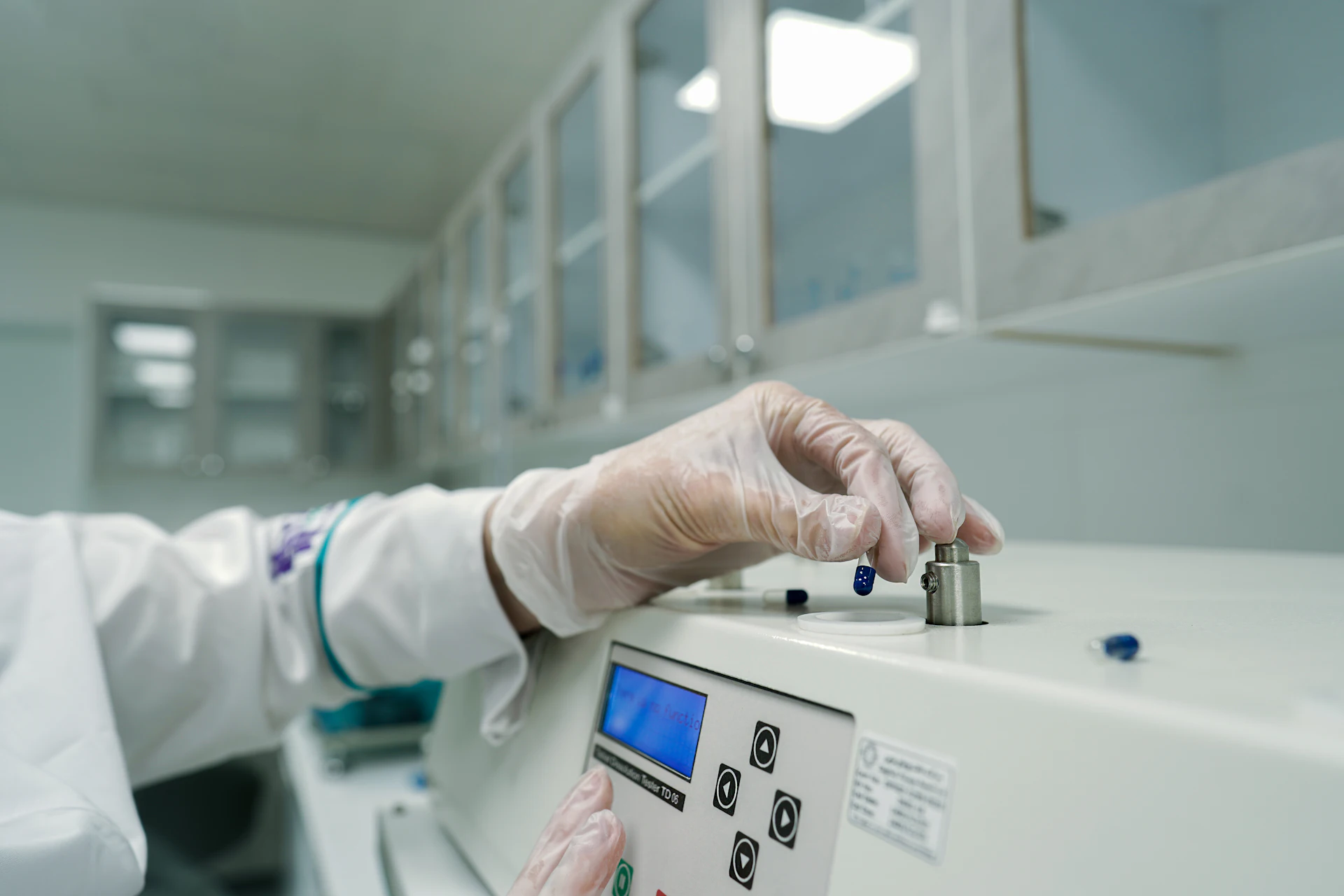 Gowned operator working on a pharmaceutical production line