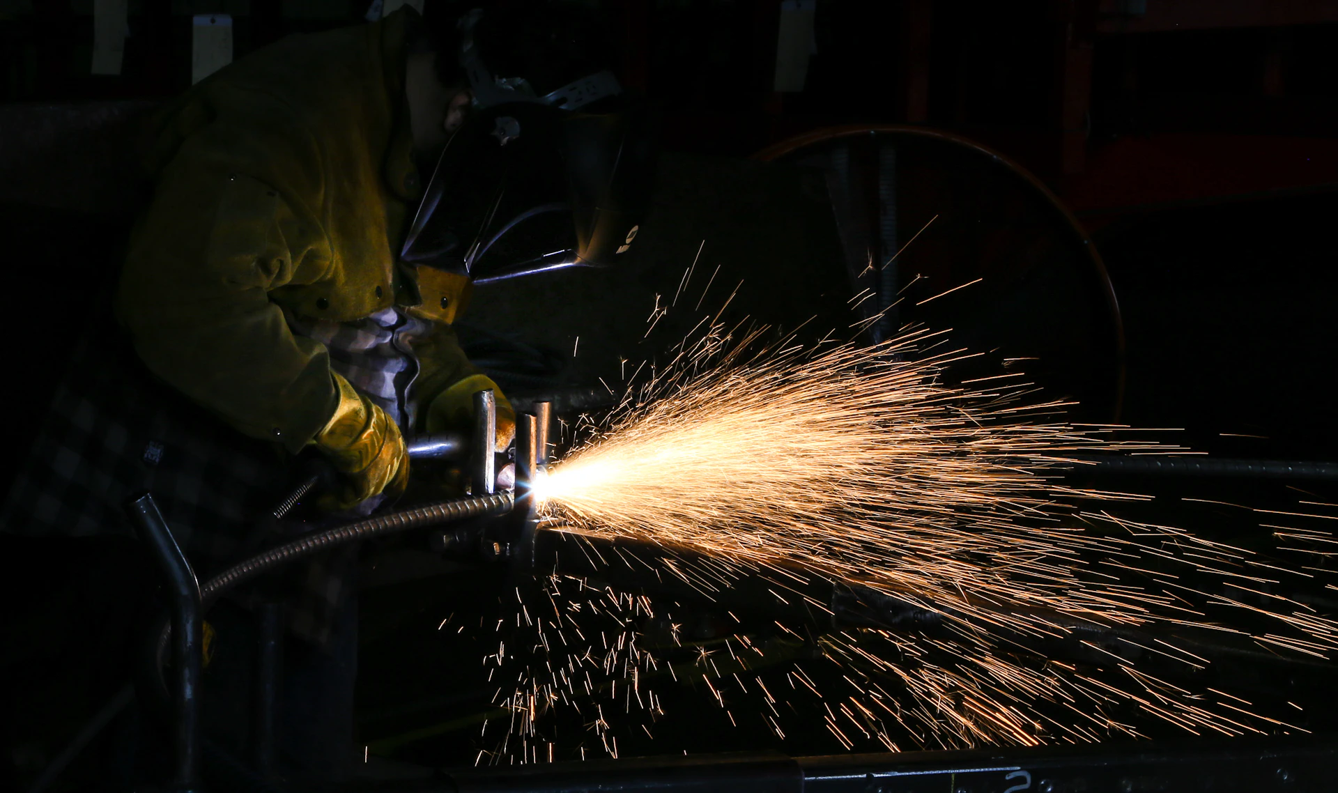 Welding sparks in a fabrication bay